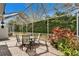 Screened-in patio with brick pavers and lush landscaping, providing a tranquil outdoor living space at 8141 Ambersweet Pl, Land O Lakes, FL 34637