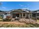 Spacious screened patio with brick flooring and outdoor seating, perfect for entertaining at 8141 Ambersweet Pl, Land O Lakes, FL 34637