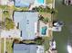 Aerial view of a home with a pool, boat dock and boat lift on a waterfront canal at 8448 Flagstone Dr, Tampa, FL 33615