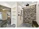 Modern bathroom featuring river rock shower, niche, and shelving at 8448 Flagstone Dr, Tampa, FL 33615