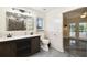 Modern bathroom featuring a double sink vanity, stone-look shower, and contemporary fixtures at 8448 Flagstone Dr, Tampa, FL 33615