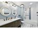 Stylish bathroom featuring a double vanity, modern fixtures, and a tiled shower at 8448 Flagstone Dr, Tampa, FL 33615