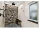 Shower features a river rock accent wall with black fixtures and granite bench at 8448 Flagstone Dr, Tampa, FL 33615