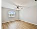 Cozy bedroom with hardwood floors, a ceiling fan and a window with a view at 8448 Flagstone Dr, Tampa, FL 33615