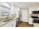 Kitchen features granite counters, stainless appliances, hardwood flooring and bright lighting at 8448 Flagstone Dr, Tampa, FL 33615