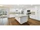 Spacious kitchen boasts a large granite island, stainless appliances, and ample white cabinetry at 8448 Flagstone Dr, Tampa, FL 33615