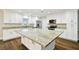 Bright, modern kitchen with a large island, stainless steel appliances and granite countertops at 8448 Flagstone Dr, Tampa, FL 33615