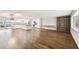 Hardwood flooring throughout this open-concept living space with kitchen and bookcase at 8448 Flagstone Dr, Tampa, FL 33615