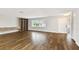 Bright room with large window, hardwood flooring, built-in shelving and front door at 8448 Flagstone Dr, Tampa, FL 33615