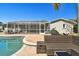 Enjoy lounging near the pool and screened-in lanai with comfortable wicker outdoor furniture at 8448 Flagstone Dr, Tampa, FL 33615
