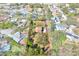 An aerial view of a home featuring mature trees, a well-manicured lawn, and ample space within a defined boundary at 9222 134Th St, Seminole, FL 33776