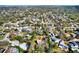 Aerial view displays home nestled among mature trees within a vibrant residential neighborhood at 9222 134Th St, Seminole, FL 33776