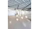 Large finished basement with utility sink, finished concrete floor, and modern lighting at 9222 134Th St, Seminole, FL 33776