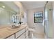 Bright bathroom featuring a white vanity, marble countertop, and walk-in shower with glass door at 9222 134Th St, Seminole, FL 33776