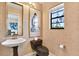 Unique half-bath features designer wallpaper, ornate mirror, and modern sink at 9222 134Th St, Seminole, FL 33776