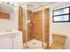 Bathroom featuring tile shower with glass doors, white vanity and neutral tile floors at 9222 134Th St, Seminole, FL 33776