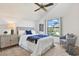 Bedroom with neutral colors, comfortable seating, a stylish cabinet, and a serene outdoor view at 9222 134Th St, Seminole, FL 33776
