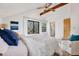 Bright bedroom with vaulted ceilings, ceiling fan, and access to a private balcony at 9222 134Th St, Seminole, FL 33776