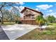 Charming two-story home with balconies, mature landscaping, and large driveway at 9222 134Th St, Seminole, FL 33776
