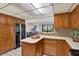Functional kitchen with ample cabinet space, white countertops, and mosaic tile backsplash at 9222 134Th St, Seminole, FL 33776