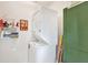 The laundry room features a stacked washer and dryer unit, and some storage on the adjacent wall at 9222 134Th St, Seminole, FL 33776