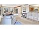 Bright living room featuring large windows, a decorative beam, and a view into an eat-in kitchen with bar stool seating at 9222 134Th St, Seminole, FL 33776
