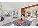 Open concept living room and dining area with hardwood fireplace, beam accent, and patio access to the outdoor area at 9222 134Th St, Seminole, FL 33776