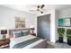 This cozy bedroom features a queen bed, ceiling fan, and ample closet space, perfect for relaxation at 9607 N 13Th St, Tampa, FL 33612