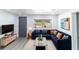 Bright living room boasts a comfortable navy sectional, stylish decor, and lots of natural light from the window at 9607 N 13Th St, Tampa, FL 33612