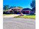 Charming single-Gathering home with a well-manicured lawn, brick mailbox, and an attached garage at 10044 Twelve Oaks Ct, Weeki Wachee, FL 34613