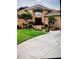 Charming front exterior featuring a well-manicured lawn, mature landscaping and a brick facade at 10044 Twelve Oaks Ct, Weeki Wachee, FL 34613