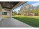 A covered porch looks out to a generous lawn area, providing outdoor living and entertaining at 1015 1/2 W Charter St, Tampa, FL 33602