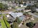 Spacious home with a screened-in pool, mature palm trees, and lush green landscaping at 10302 Belltower St, Spring Hill, FL 34608