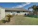 The property features a large, grassy backyard, an enclosed pool area and mature landscaping at 10302 Belltower St, Spring Hill, FL 34608