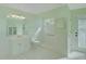 Bright bathroom with shower, sink, and white tile flooring offers a clean and functional space at 10302 Belltower St, Spring Hill, FL 34608