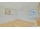 Cozy dining area with view of backyard, featuring a modern, woven light fixture at 10302 Belltower St, Spring Hill, FL 34608