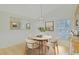 Cozy dining area with a round table, four chairs, wainscoting, and natural light from a window at 10302 Belltower St, Spring Hill, FL 34608