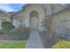 Charming home featuring a decorative front door, manicured landscaping, and a brick paver walkway at 10302 Belltower St, Spring Hill, FL 34608