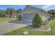 Two-car garage with screened doors with a paved driveway and mature landscaping at 10302 Belltower St, Spring Hill, FL 34608