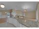 Modern kitchen with granite countertops, breakfast bar, and an open layout at 10302 Belltower St, Spring Hill, FL 34608