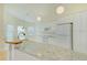 Bright kitchen featuring white cabinets, granite countertops, and stainless steel appliances at 10302 Belltower St, Spring Hill, FL 34608