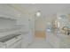 Bright kitchen featuring white cabinets, granite countertops, and stainless steel appliances at 10302 Belltower St, Spring Hill, FL 34608