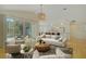 Sunlit living room featuring views of backyard pool and open-plan kitchen at 10302 Belltower St, Spring Hill, FL 34608