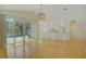 Bright living space featuring an open floor plan, backyard pool view, and modern light fixture at 10302 Belltower St, Spring Hill, FL 34608