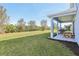 A backyard with a patio and some greenery in the distance at 10642 Mistflower Ln, Tampa, FL 33647