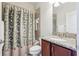 Cozy bathroom featuring a granite vanity and bath tub with shower at 10642 Mistflower Ln, Tampa, FL 33647