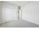 Empty bedroom with a large closet and neutral carpet at 10642 Mistflower Ln, Tampa, FL 33647