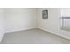Empty bedroom features a large window and neutral carpet at 10642 Mistflower Ln, Tampa, FL 33647