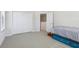 Bedroom features carpet, closet, bed with blue accents, and a view into hallway at 10642 Mistflower Ln, Tampa, FL 33647