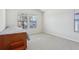 Bright bedroom with carpet, a bed, and natural light streaming through two windows at 10642 Mistflower Ln, Tampa, FL 33647